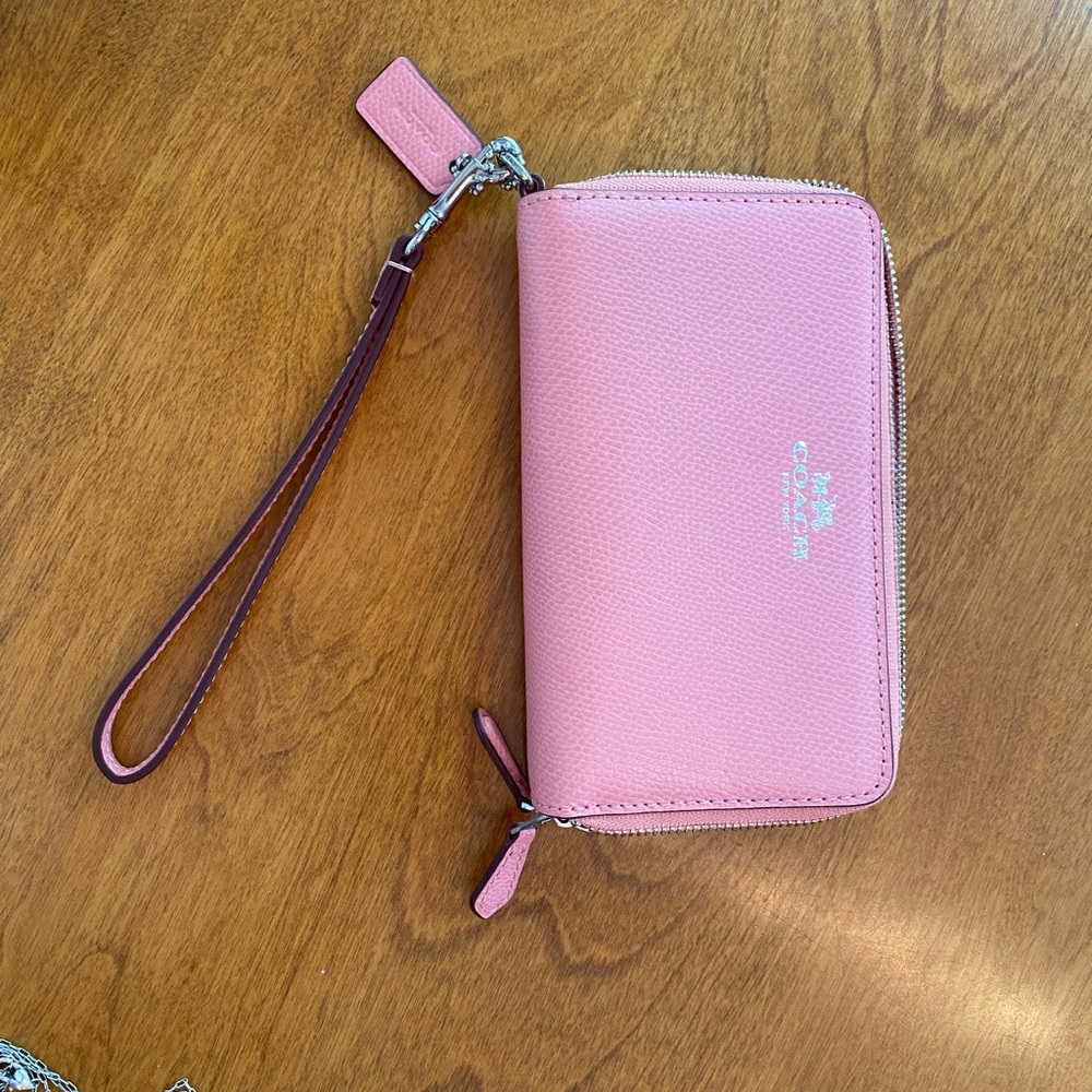 Brand new Coach zippered wallet in pink.